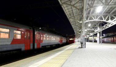 Train on Moscow passenger platform at night (Belorussky railway station) is one of the nine main railway stations in Moscow, Russia.