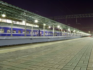 Train on Moscow passenger platform at night (Belorussky railway station) is one of the nine main railway stations in Moscow, Russia.