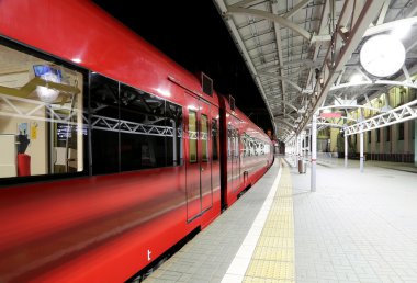 Train on Moscow passenger platform at night (Belorussky railway station) is one of the nine main railway stations in Moscow, Russia.
