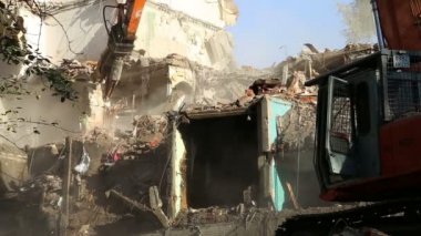 Hidrolik kırıcı ekskavatör makine yıkım eski ev üzerinde çalışıyor. Moskova, Rusya