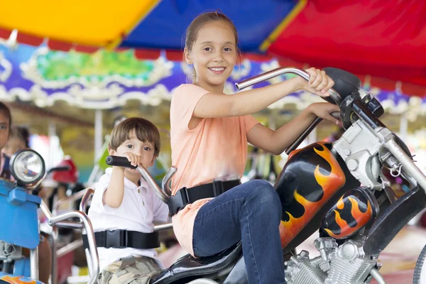 Happy children having fun riding — Stock Photo, Image