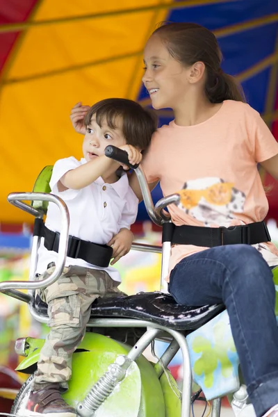 Happy children having fun riding — Stock Photo, Image