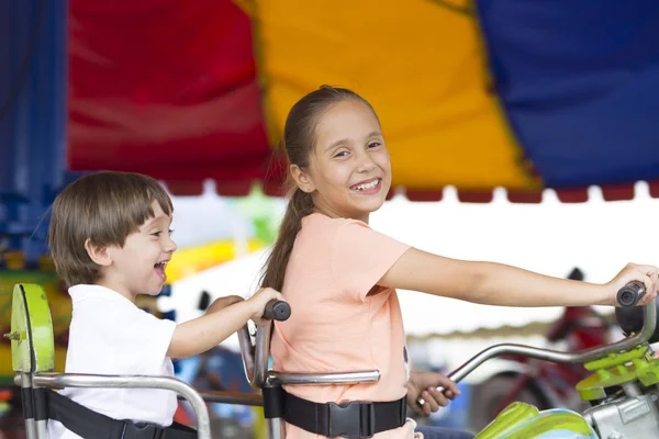 Happy children having fun riding — Stock Photo, Image