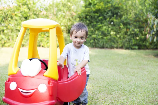 Glad liten pojke kör sin leksak — Stockfoto