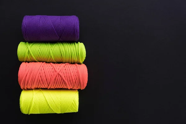 Skeins of cotton yarns for macrame knitting on dark backdrop — Stock Photo, Image