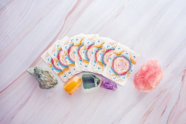 Üzerinde Tarot kartları olan kristaller ve değerli taşlar.