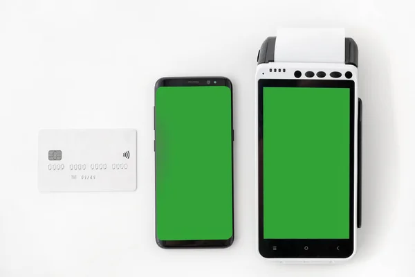 Mobile phone with blank screen with POS terminal with green screen and credit card on a white background — Stock Photo, Image