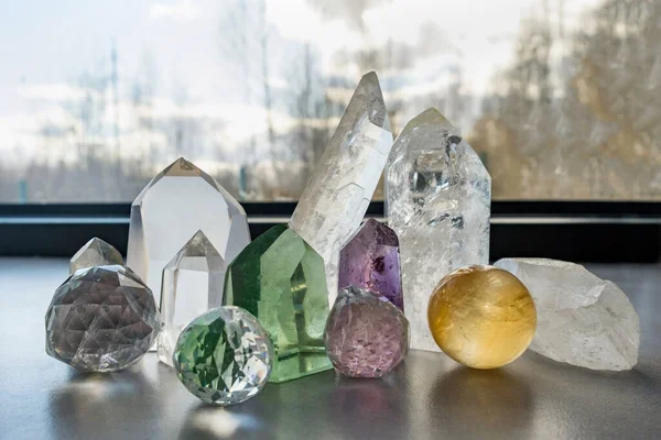 Closeup of spiritual healing crystals on a table against a window