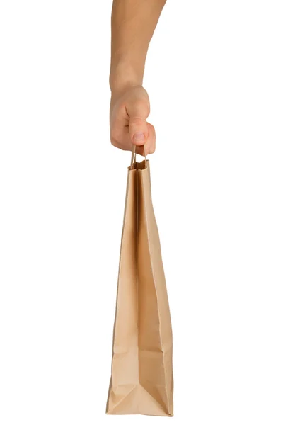 Mão segurando um saco de papel — Fotografia de Stock