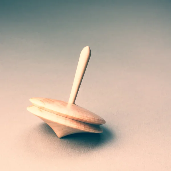 Wooden toy spinner on gray — Stock Photo, Image