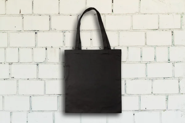 Fabric bag against brick wall — Stock Photo, Image