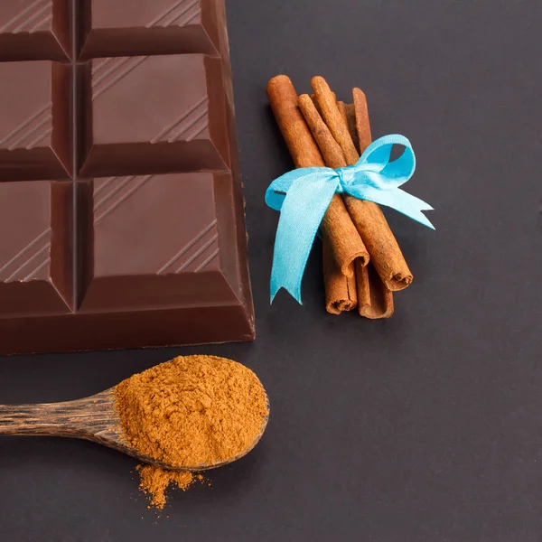 Chocolate, canela y cuchara de madera Imágenes de stock libres de derechos