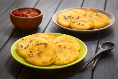 Arepa Corn Meal Patties with Hogao Sauce clipart