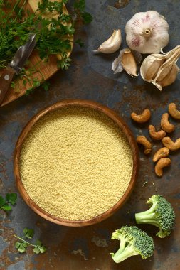 Raw Couscous in Wooden Bowl