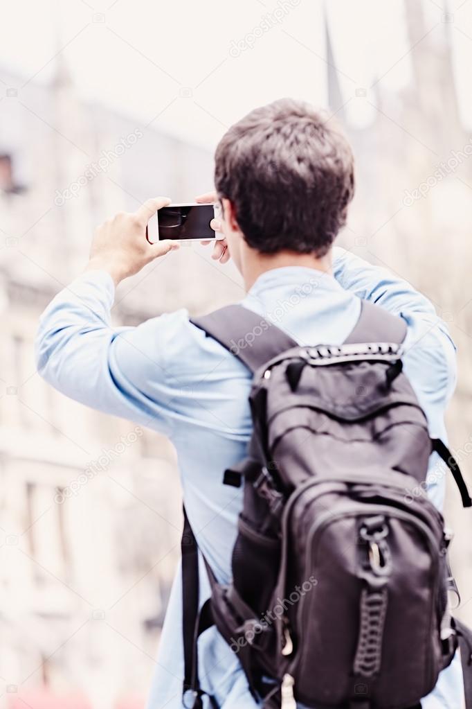 Tourist taking photo with phone