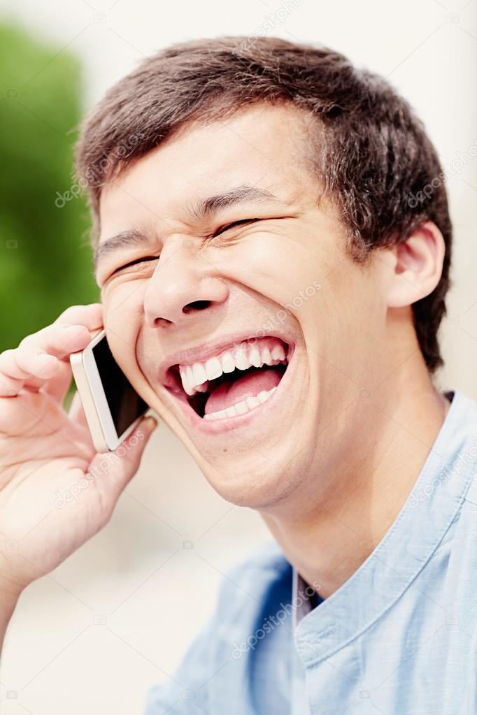 Laughing guy with smartphone headshot