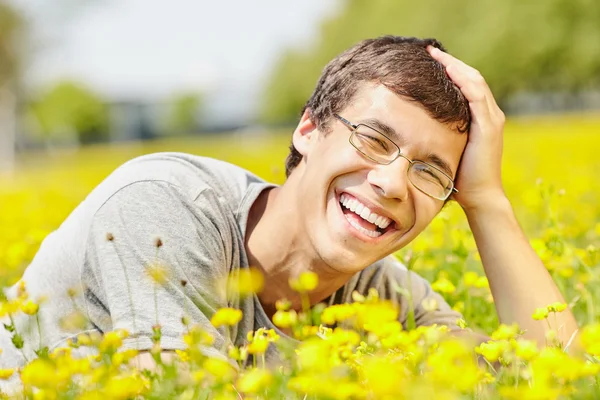 Laughing guy in spring meadow — Stock Photo, Image