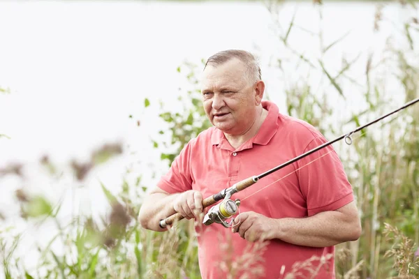 Mature angler on lake — Stock Photo, Image