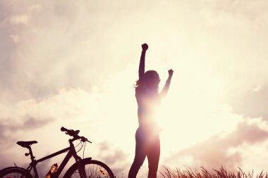 Winning girl with bike silhouette clipart
