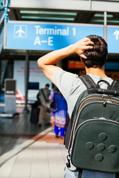 Guy near terminal sign — Stock Photo, Image