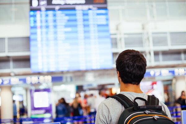 Guy near airline schedule