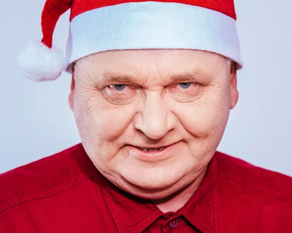 Spiteful man in Santa Claus hat — Stock Photo, Image