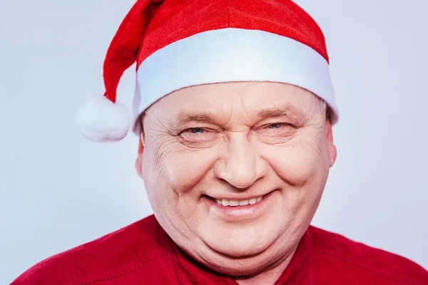 Mature man in Santa Claus hat — Stock Photo, Image