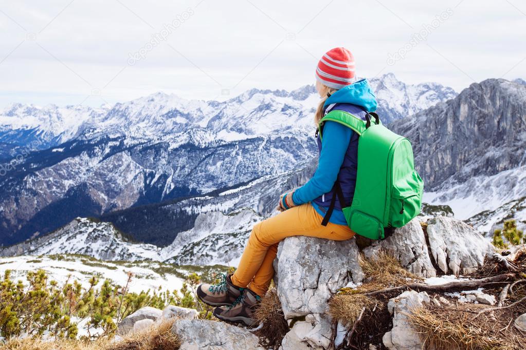 Woman resting on mountain top