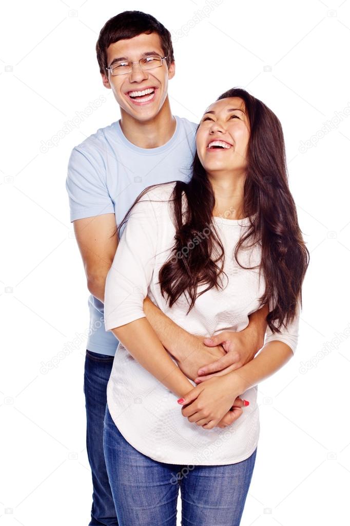 Laughing couple hugging