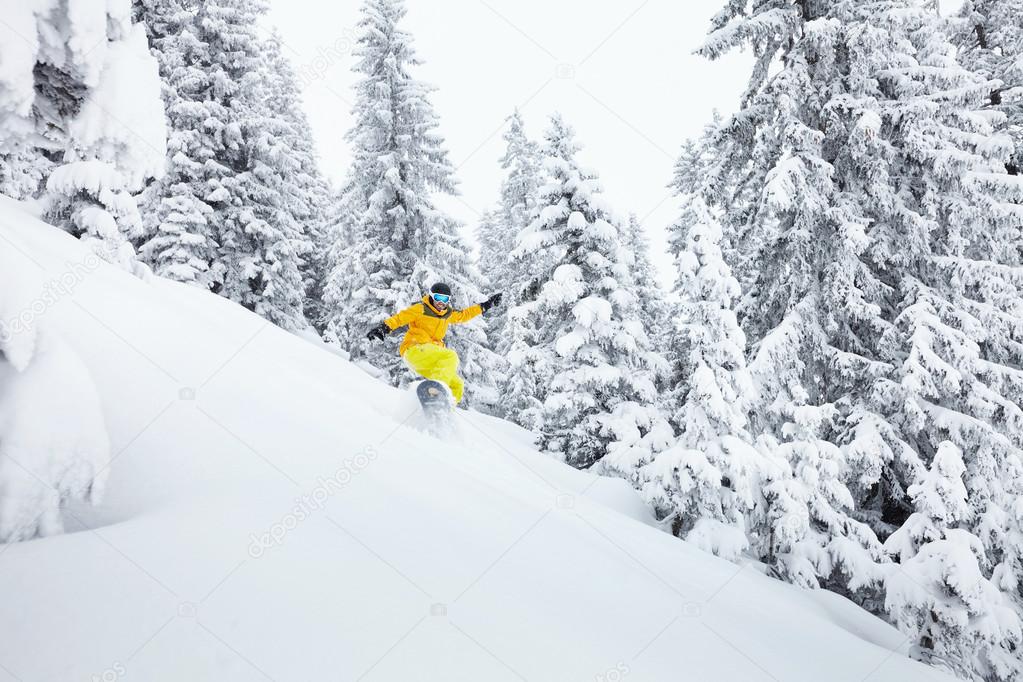 Freeride snowboarder on ski slope