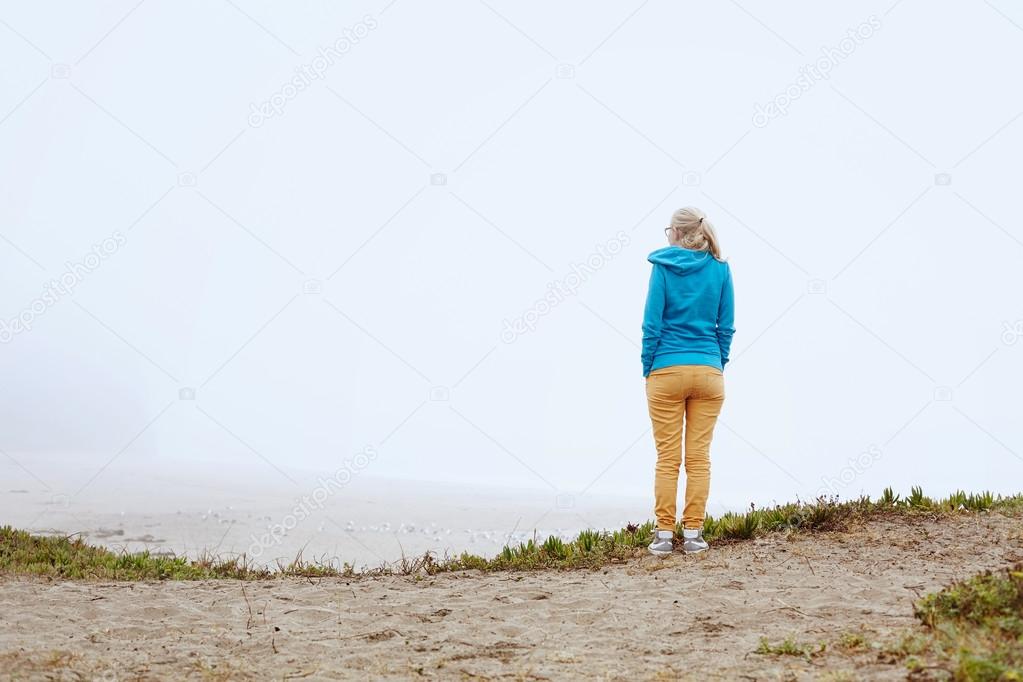 Girl on foggy beach