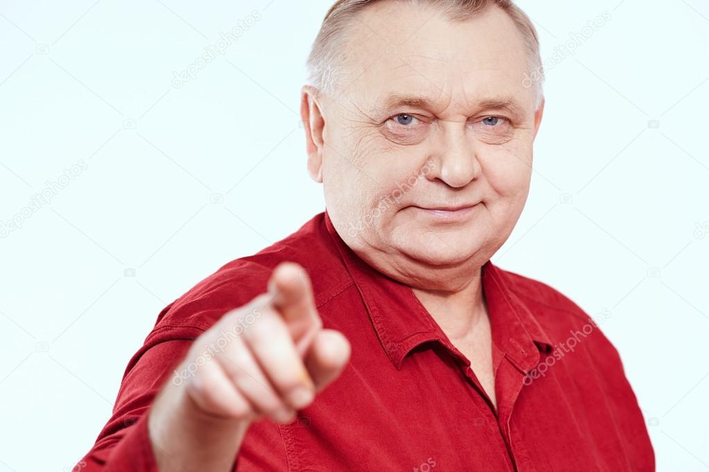 Senior with finger pointing at you