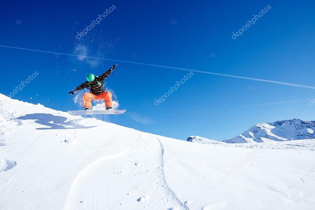 Jumping male snowboarder