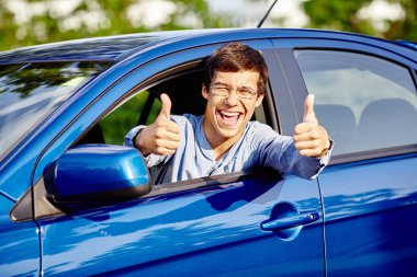Guy inside car showing thumbs up clipart