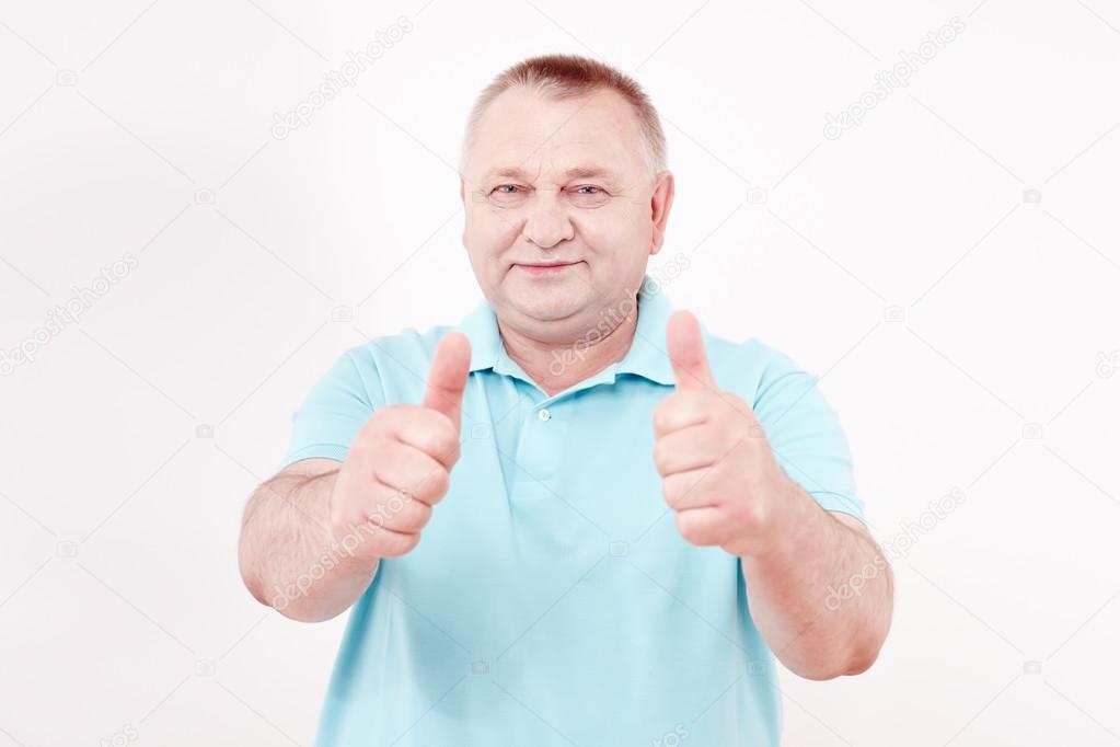 Senior showing thumbs up sign