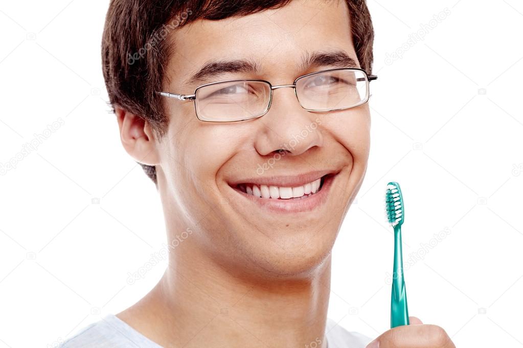 Toothy smile with brush closeup