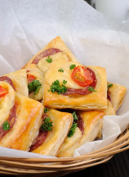 Appetizer of puff pastry with salami — Stock Photo, Image