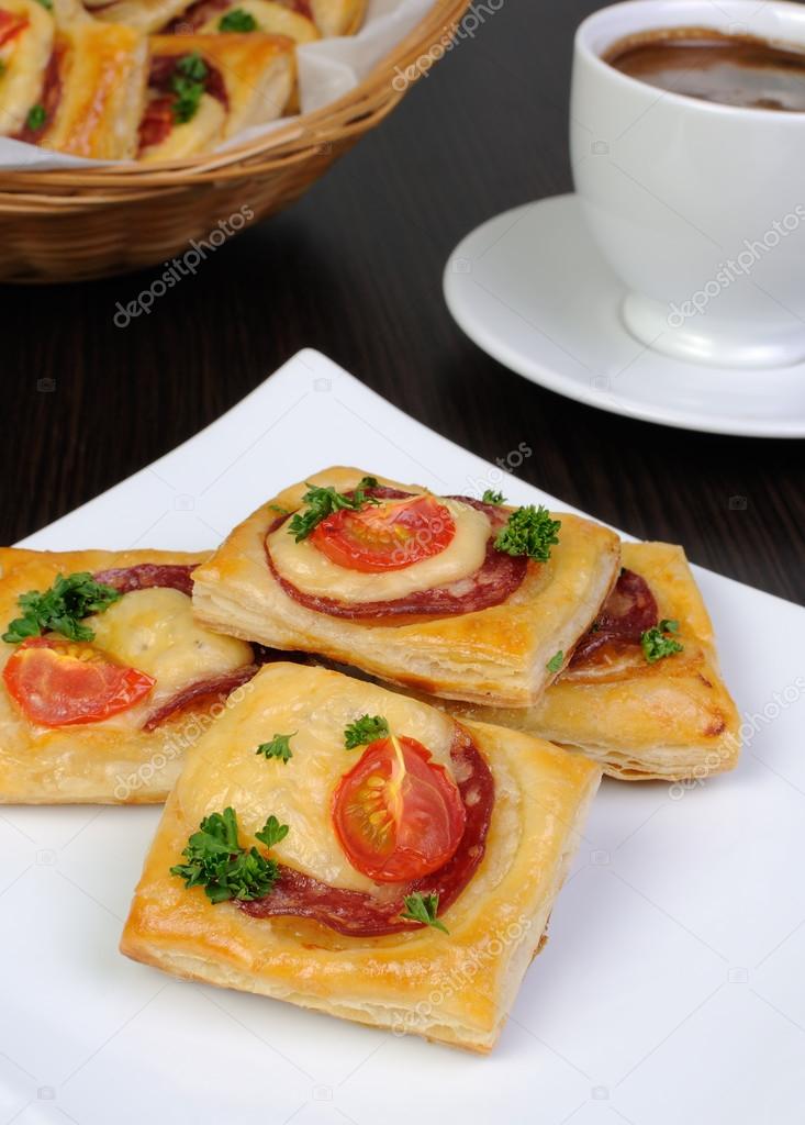 Appetizer of puff pastry with salami