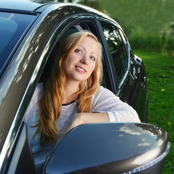 Lachende vrouw in auto — Stockfoto