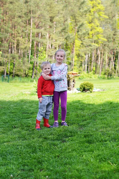 girl and her brother hugging