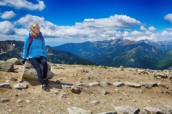 Woman sitting on stone — Stock Photo, Image