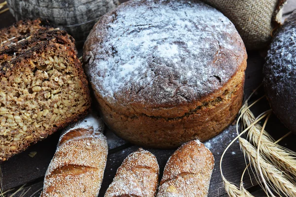 Fresh bread, buns and wheat — Stock Photo, Image