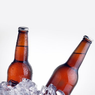 Brown bottles chilling on ice clipart