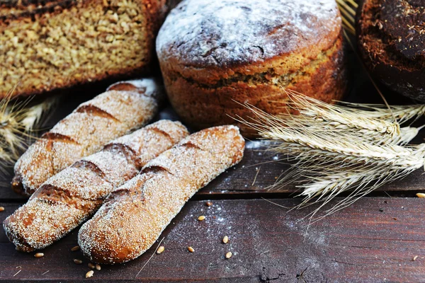 Fresh bread with buns and wheat — Stock Photo, Image