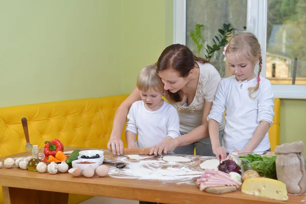 Madre con hijos preparando masa para pizzas —  Fotos de Stock