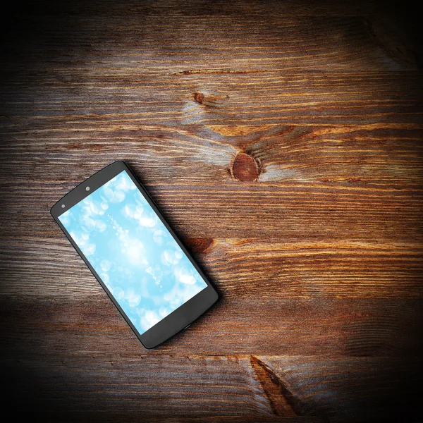 Smart phone on wooden background — Stock Photo, Image