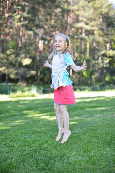 Girl on green lawn — Stock Photo, Image