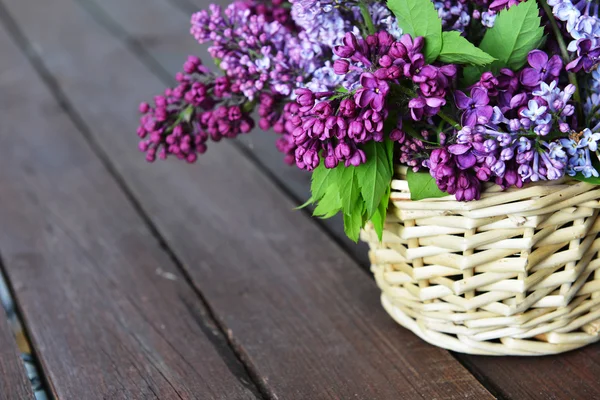 Basket with  branch of lilac — Stock Photo, Image