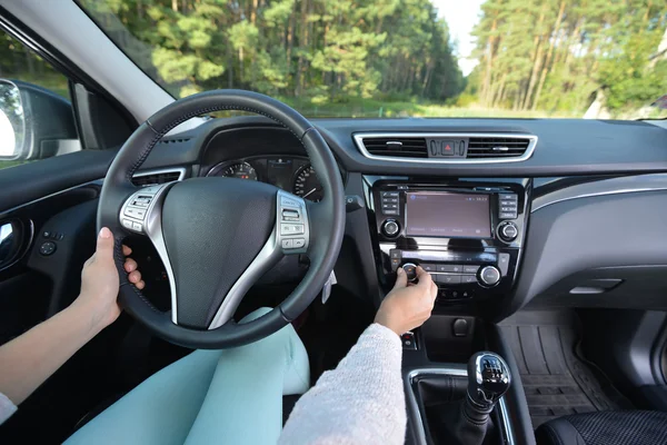 woman driving car. steering wheel view