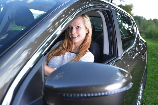 Smiling woman sit in car